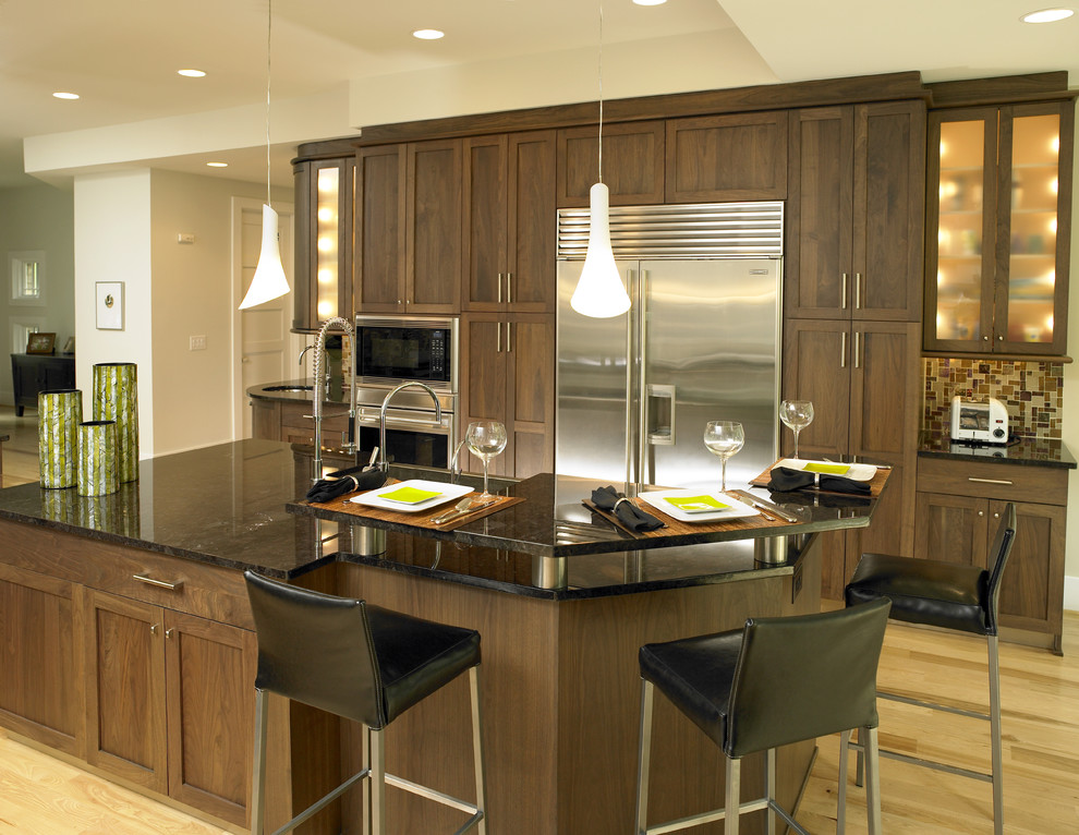 Photo of a contemporary kitchen in Charlotte with shaker cabinets and stainless steel appliances.