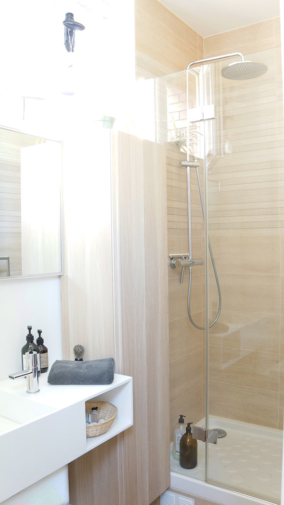 Photo of a small contemporary 3/4 bathroom in Paris with beaded inset cabinets, beige cabinets, a curbless shower, a one-piece toilet, beige tile, ceramic tile, white walls, dark hardwood floors, a console sink, engineered quartz benchtops, brown floor, a hinged shower door and white benchtops.