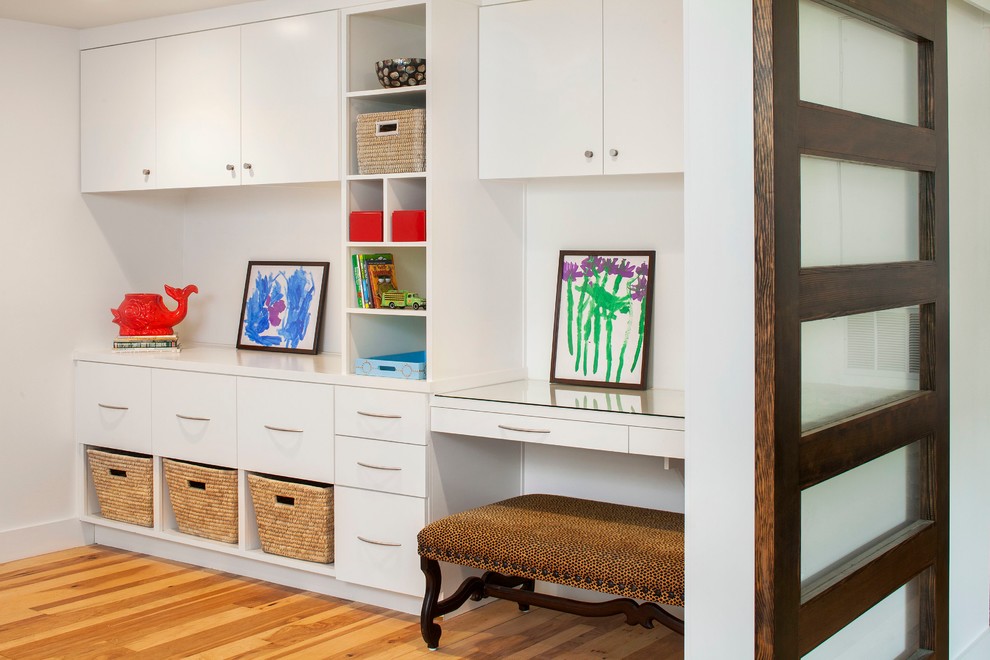 This is an example of a contemporary home office in Austin with a built-in desk.