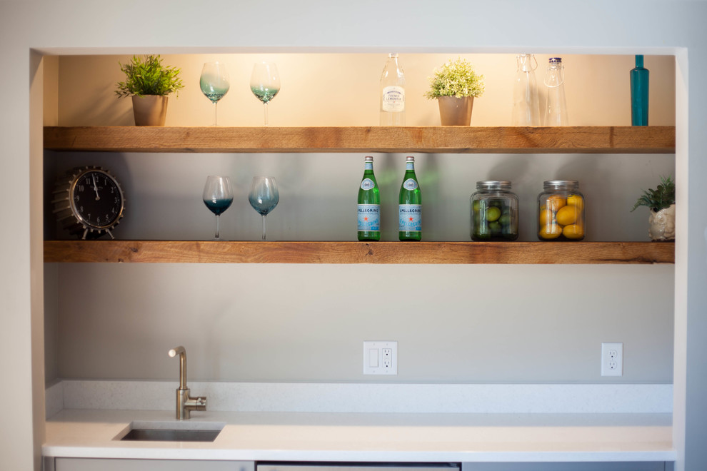 This is an example of a mid-sized modern single-wall wet bar in Salt Lake City with an undermount sink, open cabinets, medium wood cabinets and marble benchtops.