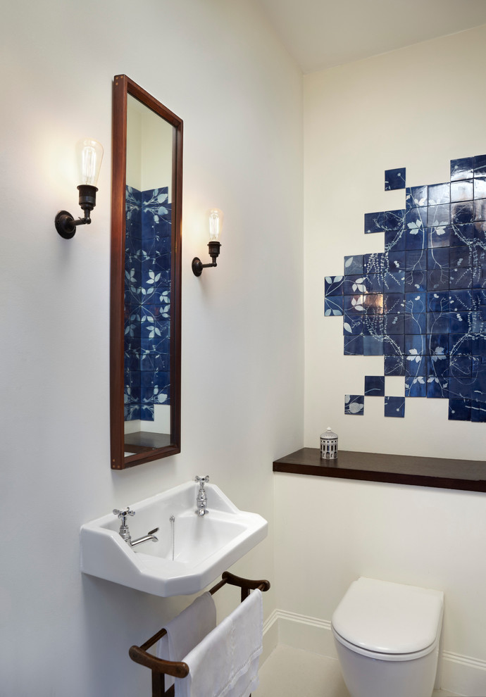 This is an example of a contemporary powder room in London with blue tile, a trough sink and ceramic tile.