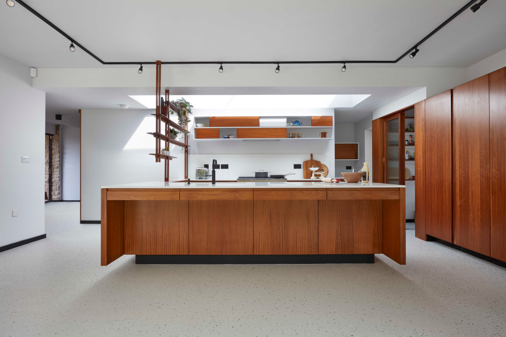 Inspiration for a large midcentury u-shaped open plan kitchen in Other with an integrated sink, flat-panel cabinets, medium wood cabinets, quartzite benchtops, white splashback, engineered quartz splashback, black appliances, with island and white benchtop.