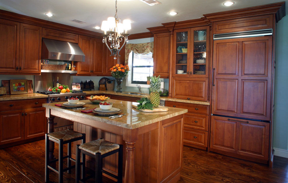 Enclosed kitchen - mid-sized transitional l-shaped medium tone wood floor enclosed kitchen idea in Miami with a drop-in sink, raised-panel cabinets, medium tone wood cabinets, granite countertops, blue backsplash, stainless steel appliances and an island