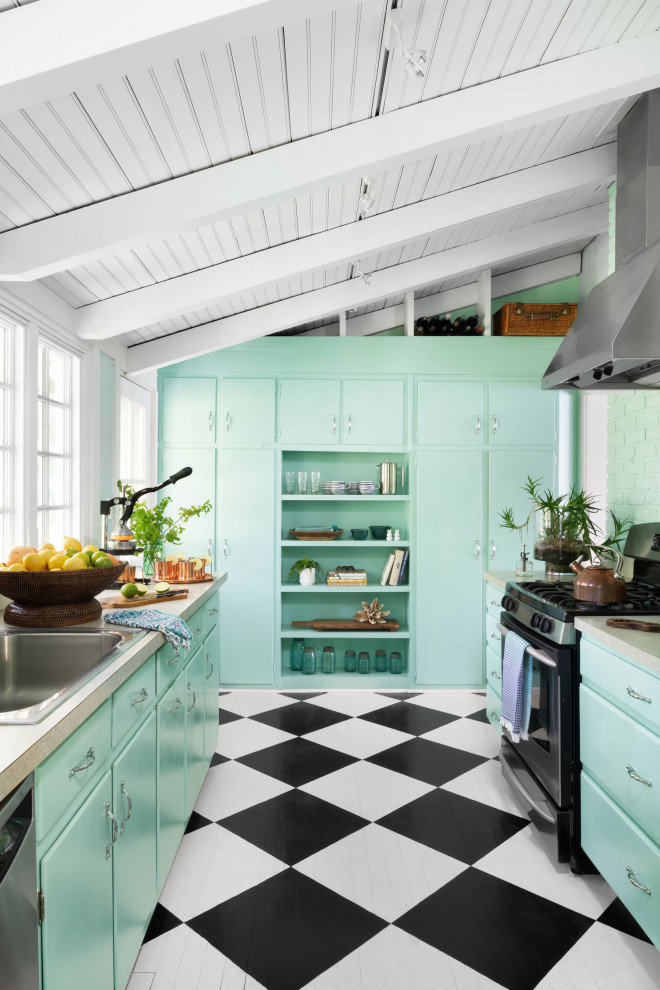 Inspiration for a beach style u-shaped kitchen in Baltimore with a drop-in sink, flat-panel cabinets, turquoise cabinets, laminate benchtops, black appliances, no island, multi-coloured floor, beige benchtop, exposed beam and vaulted.