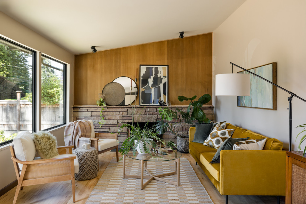 Example of a 1960s light wood floor and vaulted ceiling living room design in Seattle with a standard fireplace