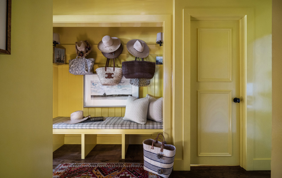 Inspiration for an entryway in Other with yellow walls, dark hardwood floors and brown floor.