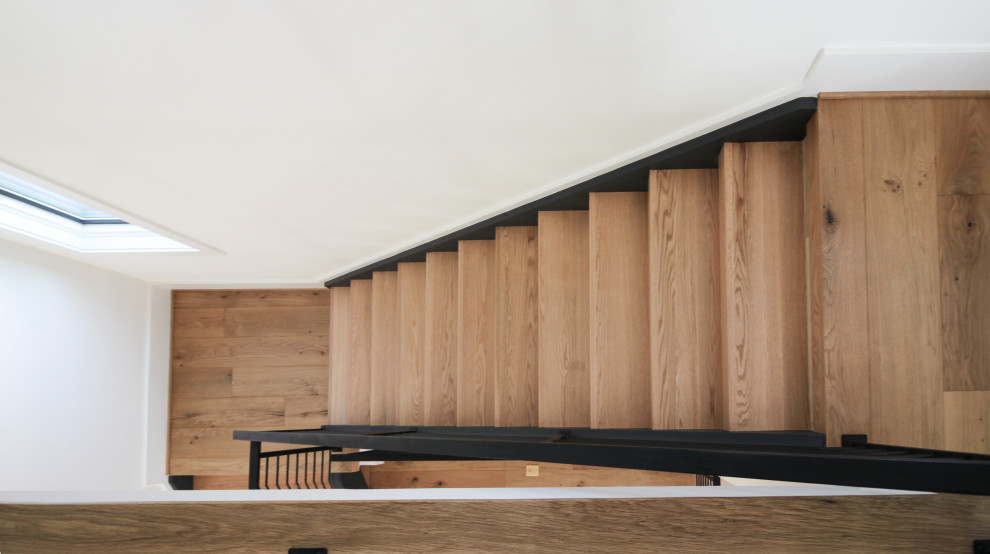 Inspiration for a mid-sized contemporary wood straight staircase in DC Metro with metal railing.