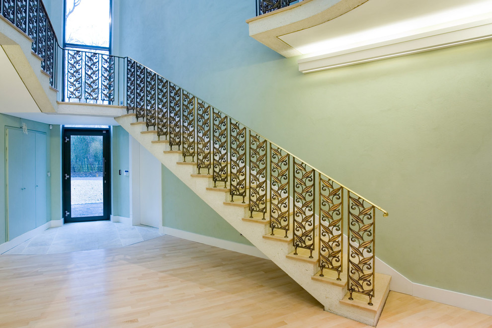 Inspiration for a transitional wood straight staircase in Other with concrete risers.