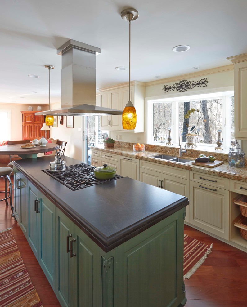 Large transitional l-shaped kitchen in Chicago with an undermount sink, raised-panel cabinets, beige cabinets, granite benchtops, panelled appliances, medium hardwood floors, with island and brown floor.
