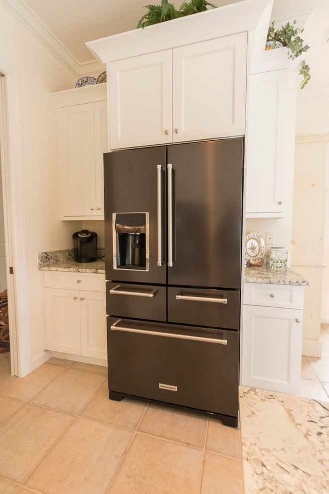 Eat-in kitchen - large transitional porcelain tile eat-in kitchen idea in Miami with an undermount sink, shaker cabinets, white cabinets, granite countertops, gray backsplash, stone slab backsplash, black appliances and an island