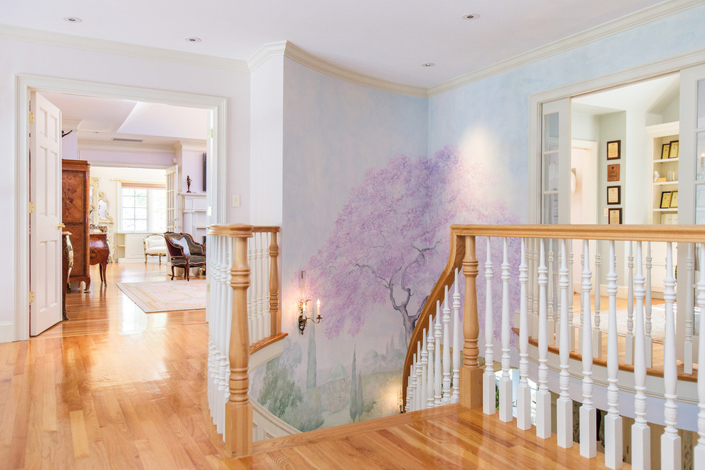 This is an example of a large traditional hallway in Boston with multi-coloured walls and medium hardwood floors.