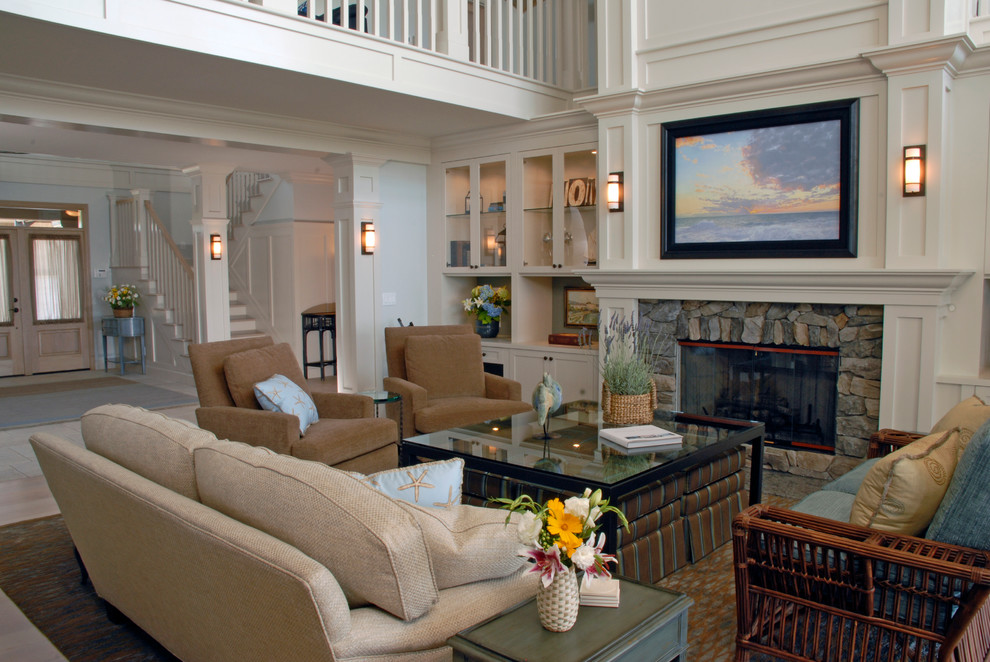 This is an example of a large arts and crafts open concept living room in Seattle with white walls, light hardwood floors, a standard fireplace, a stone fireplace surround and a concealed tv.