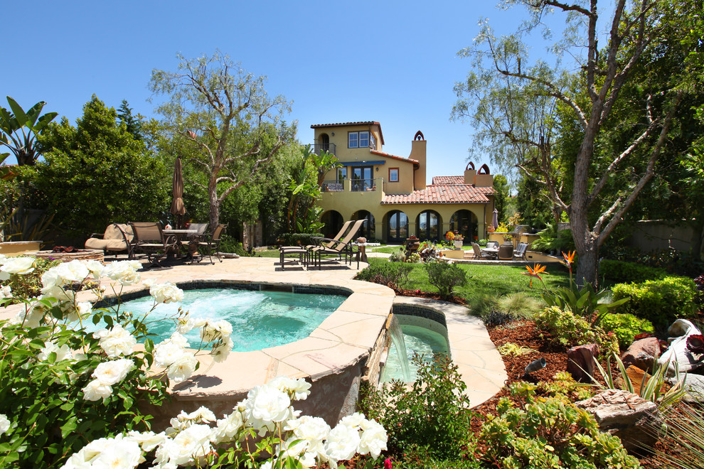 This is an example of a mediterranean backyard pool in Orange County.