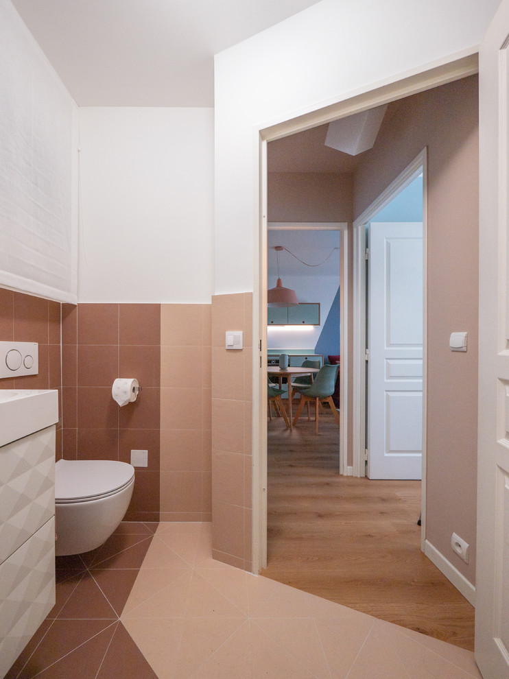 Small contemporary 3/4 bathroom in Milan with raised-panel cabinets, white cabinets, a corner shower, a two-piece toilet, multi-coloured tile, porcelain tile, white walls, porcelain floors, a console sink, solid surface benchtops, multi-coloured floor, a sliding shower screen and white benchtops.