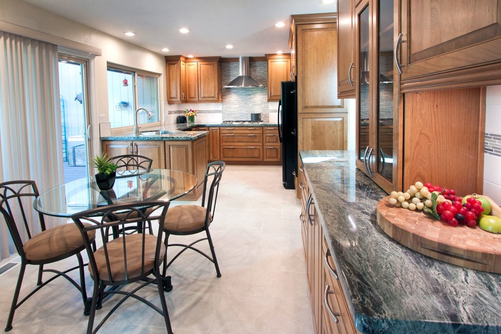 Example of a small transitional u-shaped porcelain tile eat-in kitchen design in San Francisco with a single-bowl sink, raised-panel cabinets, medium tone wood cabinets, granite countertops, multicolored backsplash, mosaic tile backsplash, black appliances and a peninsula