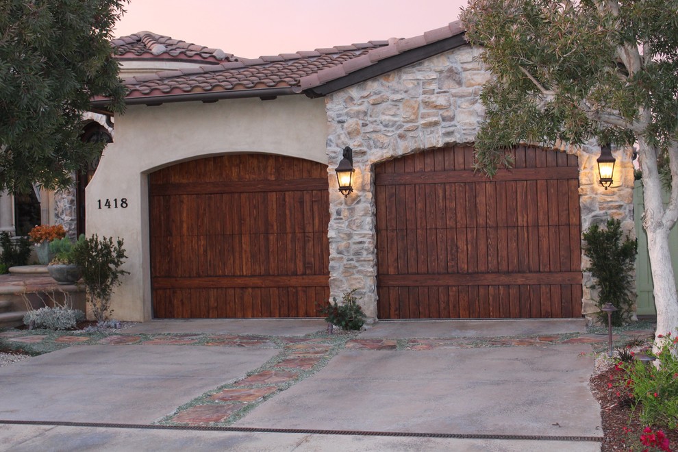 Inspiration for a large mediterranean attached two-car garage in Orange County.