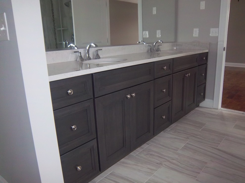Mid-sized transitional master porcelain tile porcelain tile and beige floor alcove bathtub photo with recessed-panel cabinets, dark wood cabinets, beige walls, an undermount sink, granite countertops and beige countertops