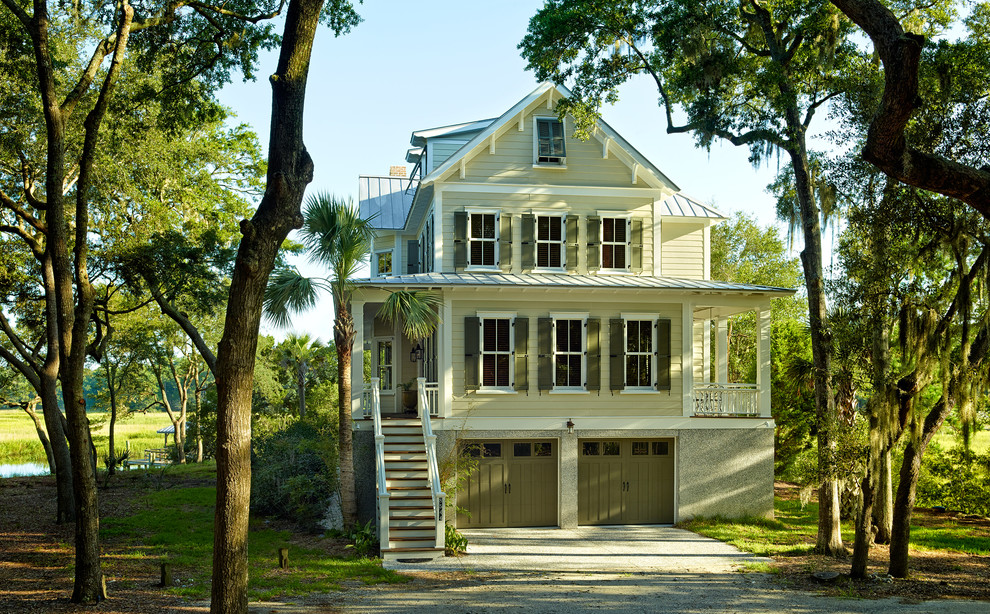 Design ideas for a mid-sized beach style three-storey green exterior in Charleston with wood siding and a gable roof.