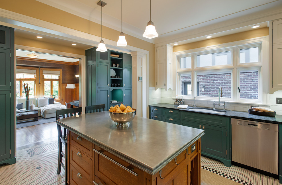 This is an example of a large traditional u-shaped separate kitchen in Seattle with a double-bowl sink, recessed-panel cabinets, dark wood cabinets, zinc benchtops, white splashback, ceramic splashback, stainless steel appliances, porcelain floors and with island.