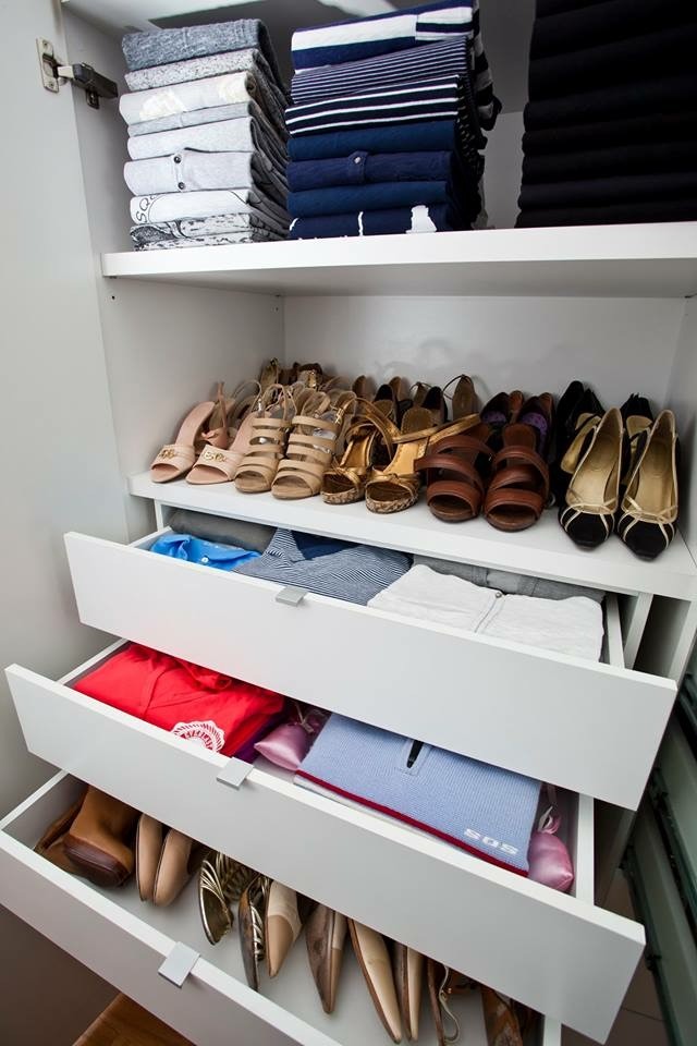 Inspiration for a mid-sized modern women's walk-in wardrobe in Sydney with open cabinets, white cabinets and light hardwood floors.