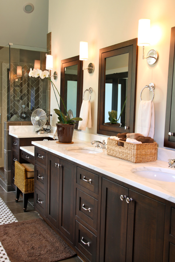 Inspiration for a large transitional master bathroom in Atlanta with recessed-panel cabinets, dark wood cabinets, an alcove shower, black tile, porcelain tile, beige walls, concrete floors, an undermount sink, marble benchtops, brown floor and a hinged shower door.
