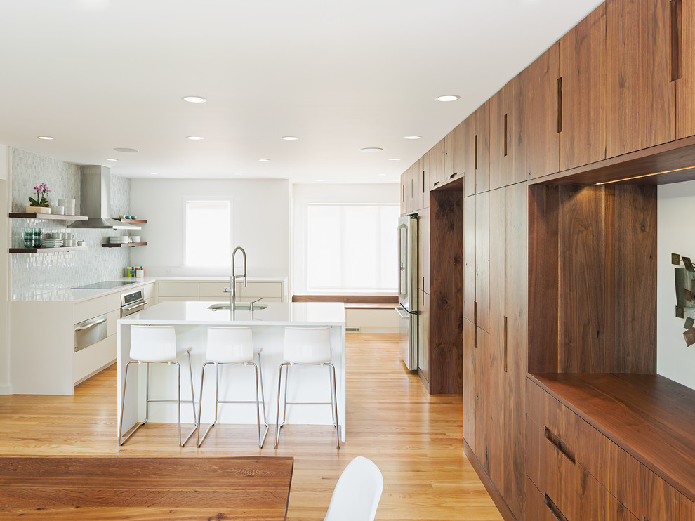 Contemporary l-shaped eat-in kitchen in Philadelphia with an undermount sink, open cabinets, medium wood cabinets, stainless steel appliances, medium hardwood floors and with island.
