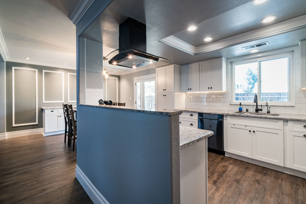 Inspiration for a mid-sized transitional u-shaped dark wood floor and brown floor eat-in kitchen remodel with an undermount sink, shaker cabinets, white cabinets, granite countertops, white backsplash, subway tile backsplash, stainless steel appliances and an island