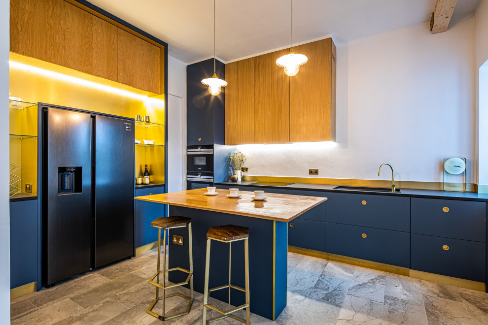 Photo of a contemporary kitchen in Manchester with metallic splashback, black appliances, marble floors, with island and black benchtop.