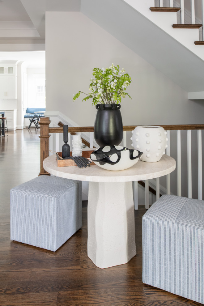 Inspiration for a large transitional dark wood floor and wainscoting foyer remodel in DC Metro with a medium wood front door
