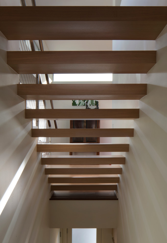 Design ideas for a contemporary wood floating staircase in San Francisco with open risers.