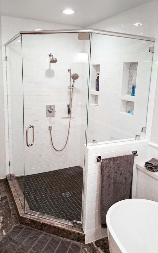 Mid-sized trendy master white tile and subway tile porcelain tile, single-sink and multicolored floor bathroom photo in Los Angeles with flat-panel cabinets, a two-piece toilet, white walls, an undermount sink, solid surface countertops, a hinged shower door, white countertops, a niche, a freestanding vanity and white cabinets