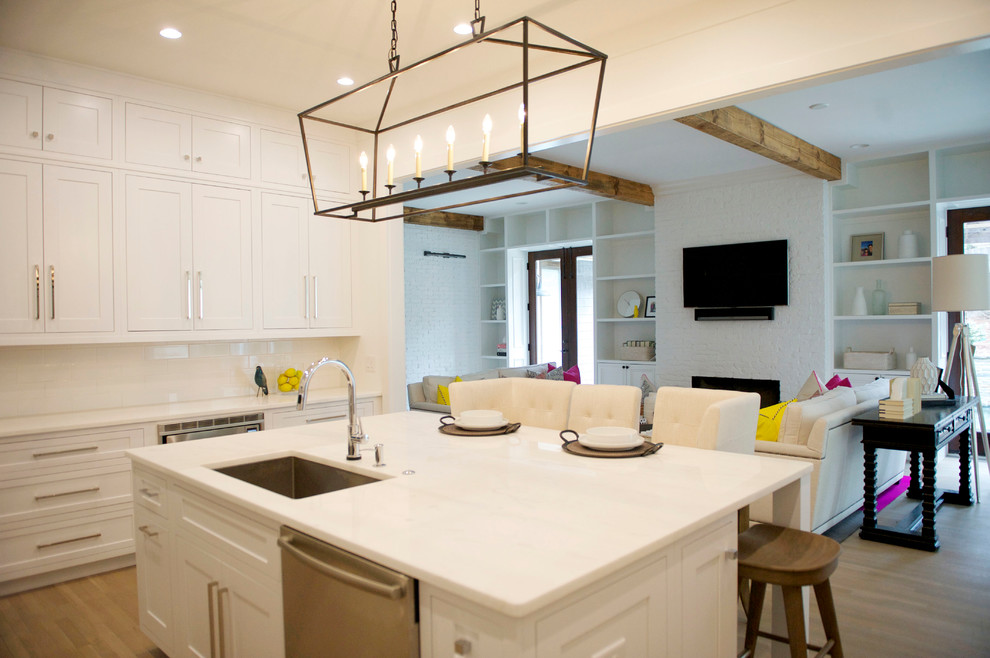 Inspiration for a mid-sized modern u-shaped open plan kitchen in Atlanta with an undermount sink, shaker cabinets, white cabinets, marble benchtops, white splashback, subway tile splashback, stainless steel appliances, light hardwood floors and with island.