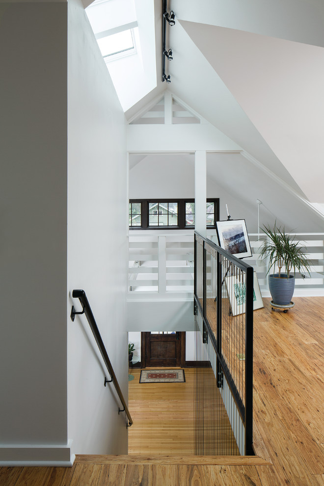 Design ideas for a mid-sized transitional wood straight staircase in Indianapolis with open risers and metal railing.