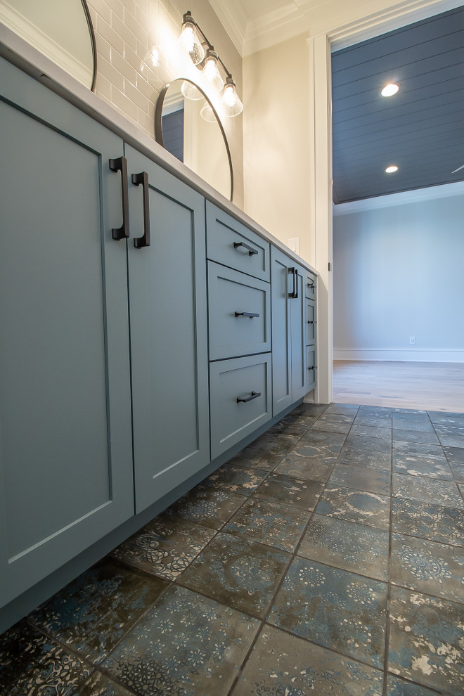 Photo of a large traditional master bathroom in Cleveland with recessed-panel cabinets, blue cabinets, beige tile, subway tile, beige walls, ceramic floors, a drop-in sink, multi-coloured floor, blue benchtops, a double vanity and a built-in vanity.