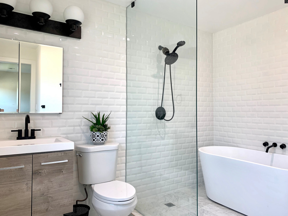 Design ideas for a small transitional master wet room bathroom in Los Angeles with flat-panel cabinets, medium wood cabinets, a freestanding tub, a one-piece toilet, white tile, subway tile, white walls, ceramic floors, a wall-mount sink, white floor, an open shower, white benchtops, a single vanity, a floating vanity and vaulted.