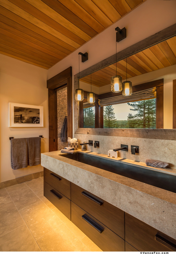Design ideas for a transitional kids bathroom in Sacramento with an undermount sink, flat-panel cabinets, dark wood cabinets, limestone benchtops, an open shower, beige tile and limestone floors.