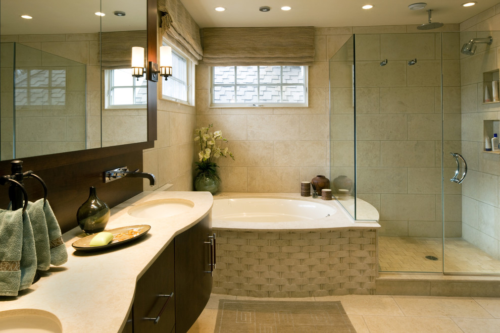 This is an example of a large contemporary master bathroom in Baltimore with an undermount sink, flat-panel cabinets, dark wood cabinets, a corner shower, a two-piece toilet, beige tile, ceramic tile, beige walls, ceramic floors and an undermount tub.