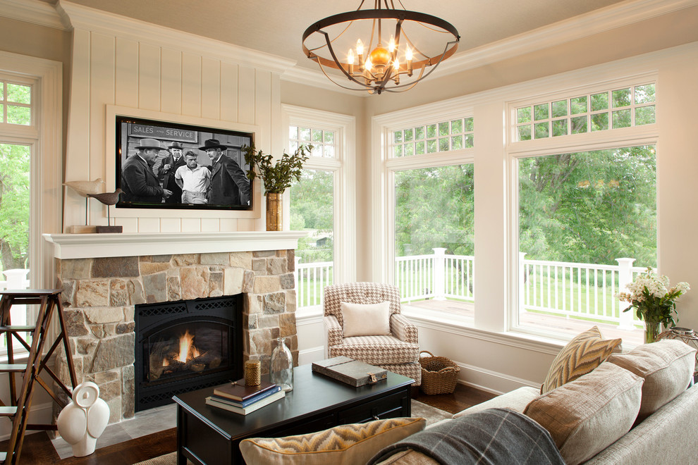 This is an example of a small traditional sunroom in Minneapolis with medium hardwood floors and a stone fireplace surround.