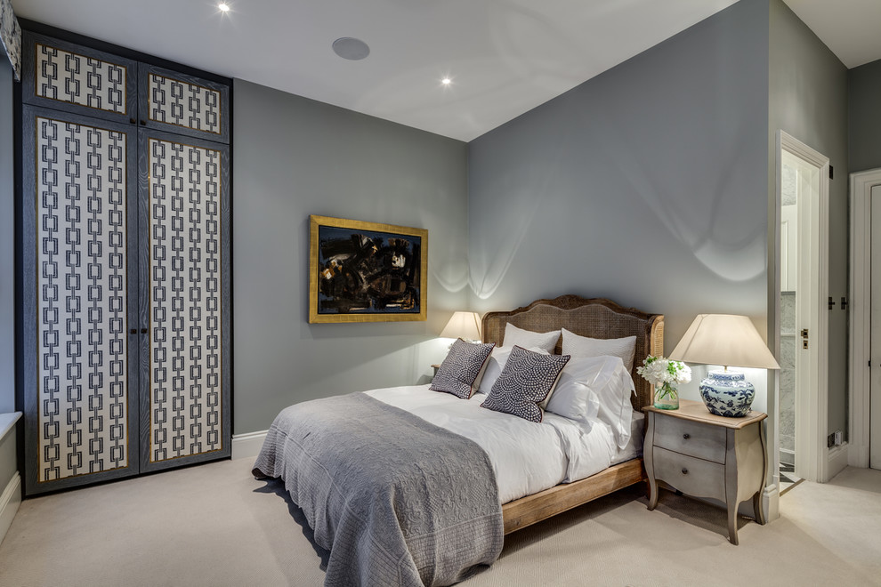 Design ideas for a transitional guest bedroom in London with grey walls and carpet.