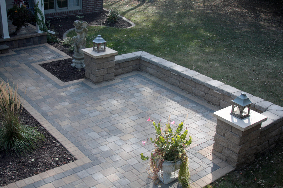 This is an example of a small traditional front yard patio in Minneapolis with concrete pavers and no cover.