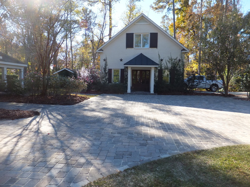 Design ideas for a large arts and crafts courtyard driveway in Other with concrete pavers.
