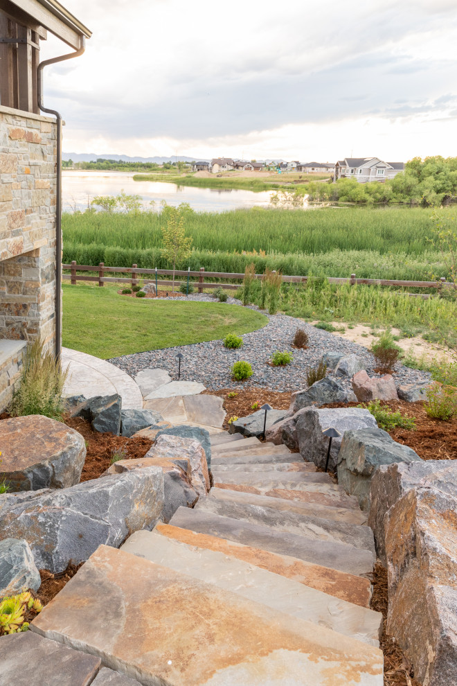 Inspiration for an expansive arts and crafts side yard full sun garden in Denver with with rock feature and mulch.