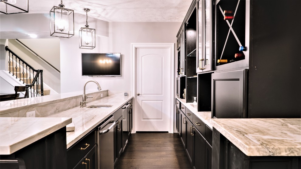 Large transitional galley dark wood floor kitchen photo with an undermount sink, furniture-like cabinets, black cabinets, marble countertops and mirror backsplash