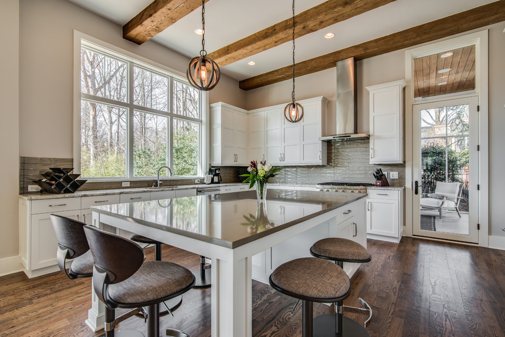 Inspiration for a large transitional u-shaped eat-in kitchen in Charlotte with an undermount sink, recessed-panel cabinets, white cabinets, quartz benchtops, grey splashback, glass tile splashback, stainless steel appliances, medium hardwood floors and with island.