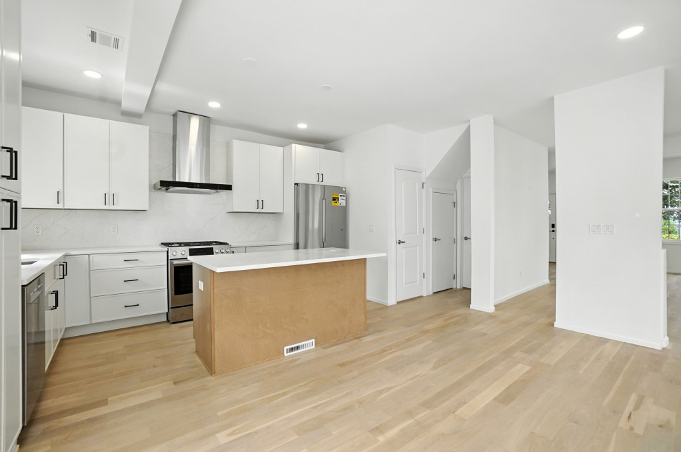 White Kitchen with Stone Counters and Gas Range