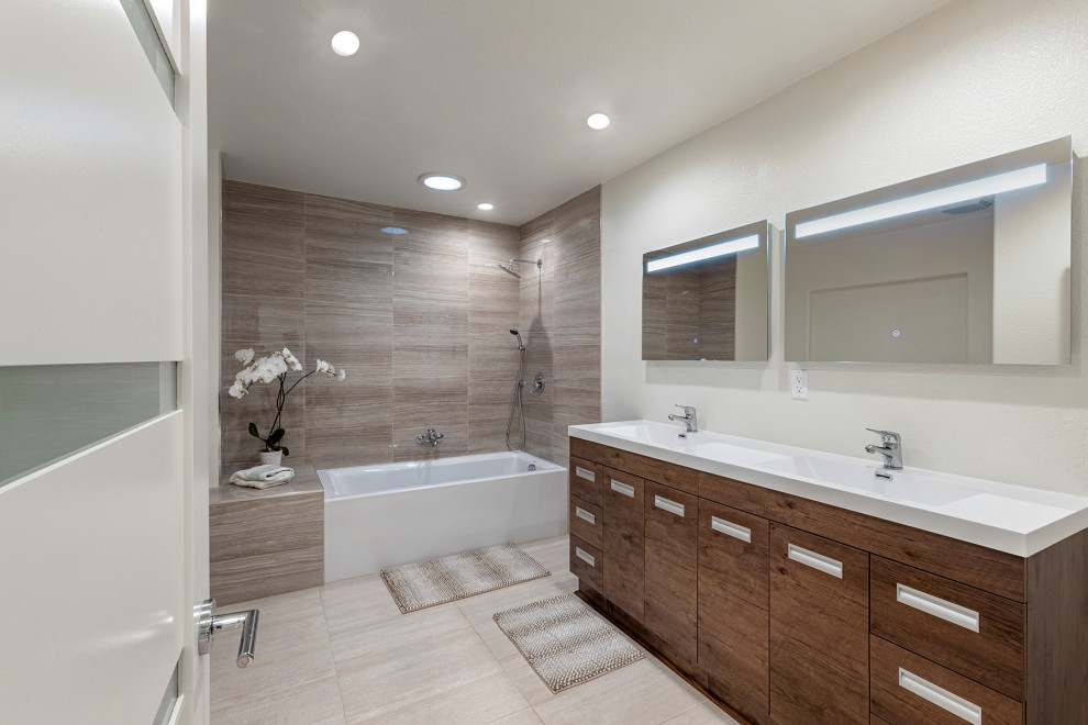 Large modern kids bathroom in Orange County with a corner shower, a two-piece toilet, white tile, ceramic tile, white walls, porcelain floors, beaded inset cabinets, brown cabinets, a corner tub, a trough sink, quartzite benchtops, brown floor, a double vanity and a built-in vanity.