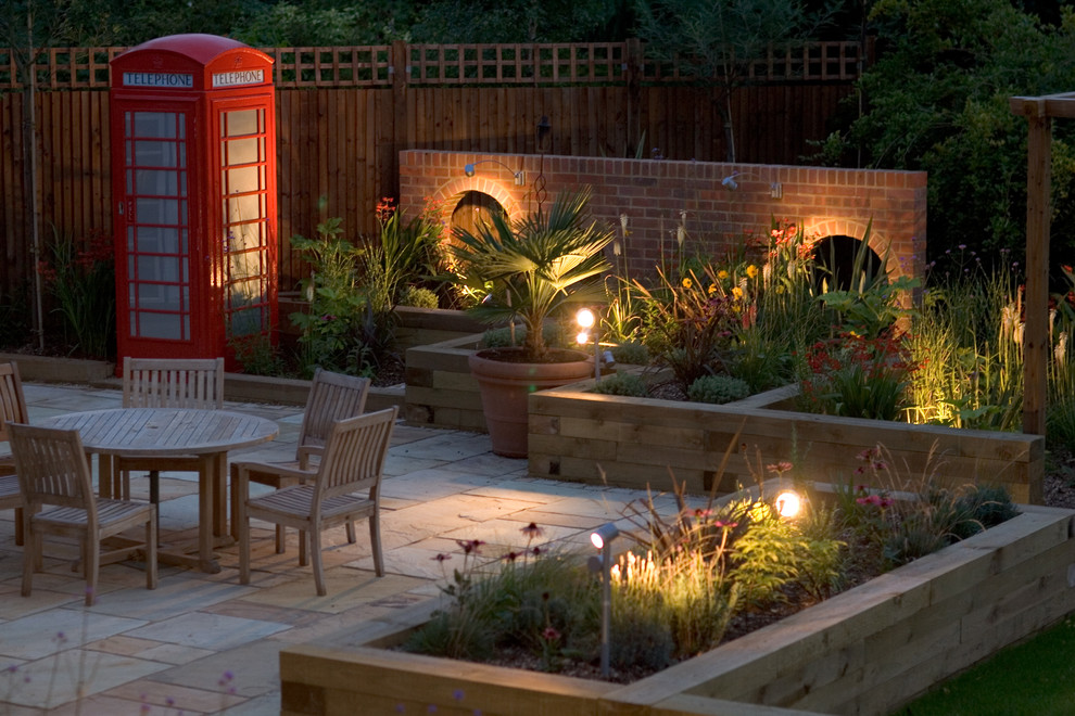 Design ideas for a bohemian back patio in Hertfordshire with a water feature.