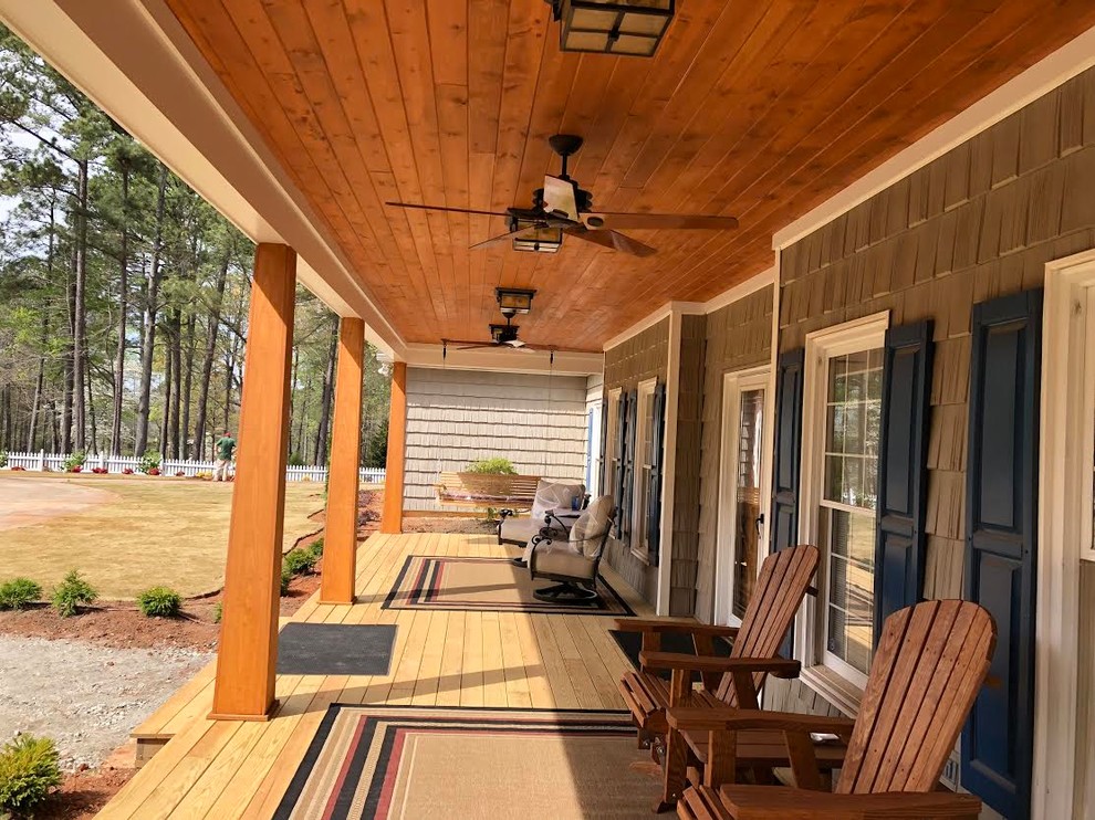 Inspiration for a mid-sized country front yard verandah in Atlanta with decking and a roof extension.