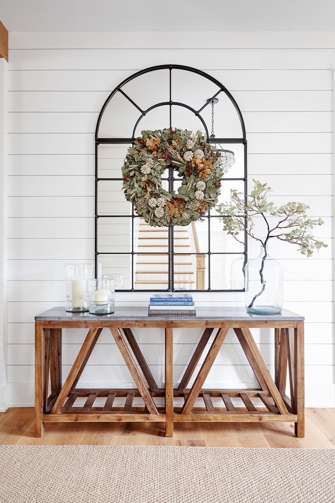 Example of a mid-sized cottage light wood floor and beige floor foyer design in Philadelphia with white walls