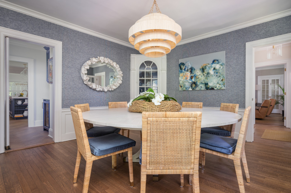 Inspiration for a mid-sized beach style separate dining room in New York with blue walls, medium hardwood floors, no fireplace, brown floor and decorative wall panelling.